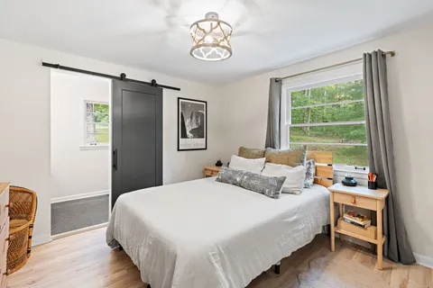 a bedroom with a bed and a chandelier