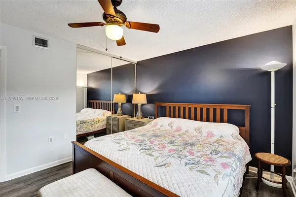 a large bedroom with two beds and a chandelier