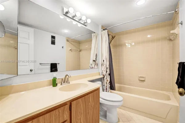 a bathroom with a sink a toilet and a large mirror