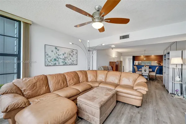 a living room with furniture and a large window