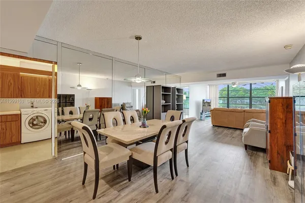 a view of a dining room with furniture window and wooden floor