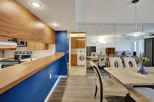 a kitchen with counter space dining table and chairs