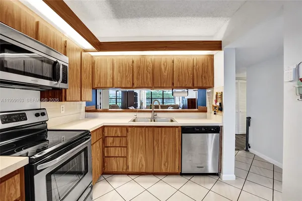 a kitchen with stainless steel appliances a sink stove and cabinets
