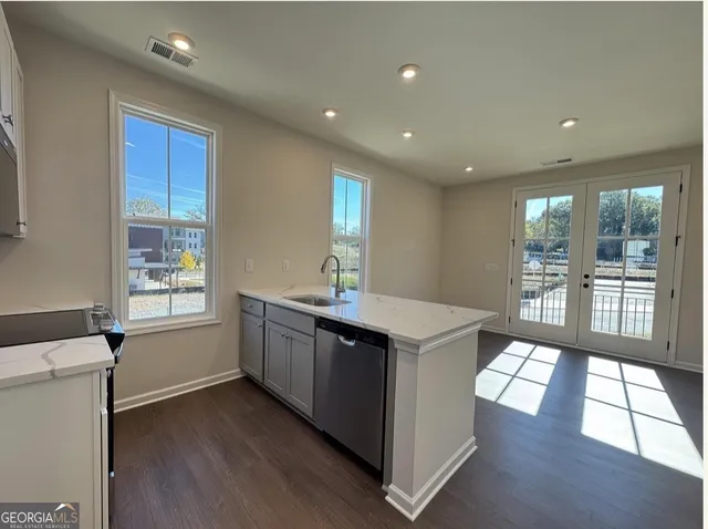 a kitchen with a sink stove and wooden cabinets