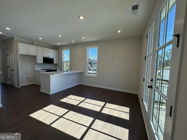 a kitchen with stainless steel appliances granite countertop a refrigerator and a stove top oven