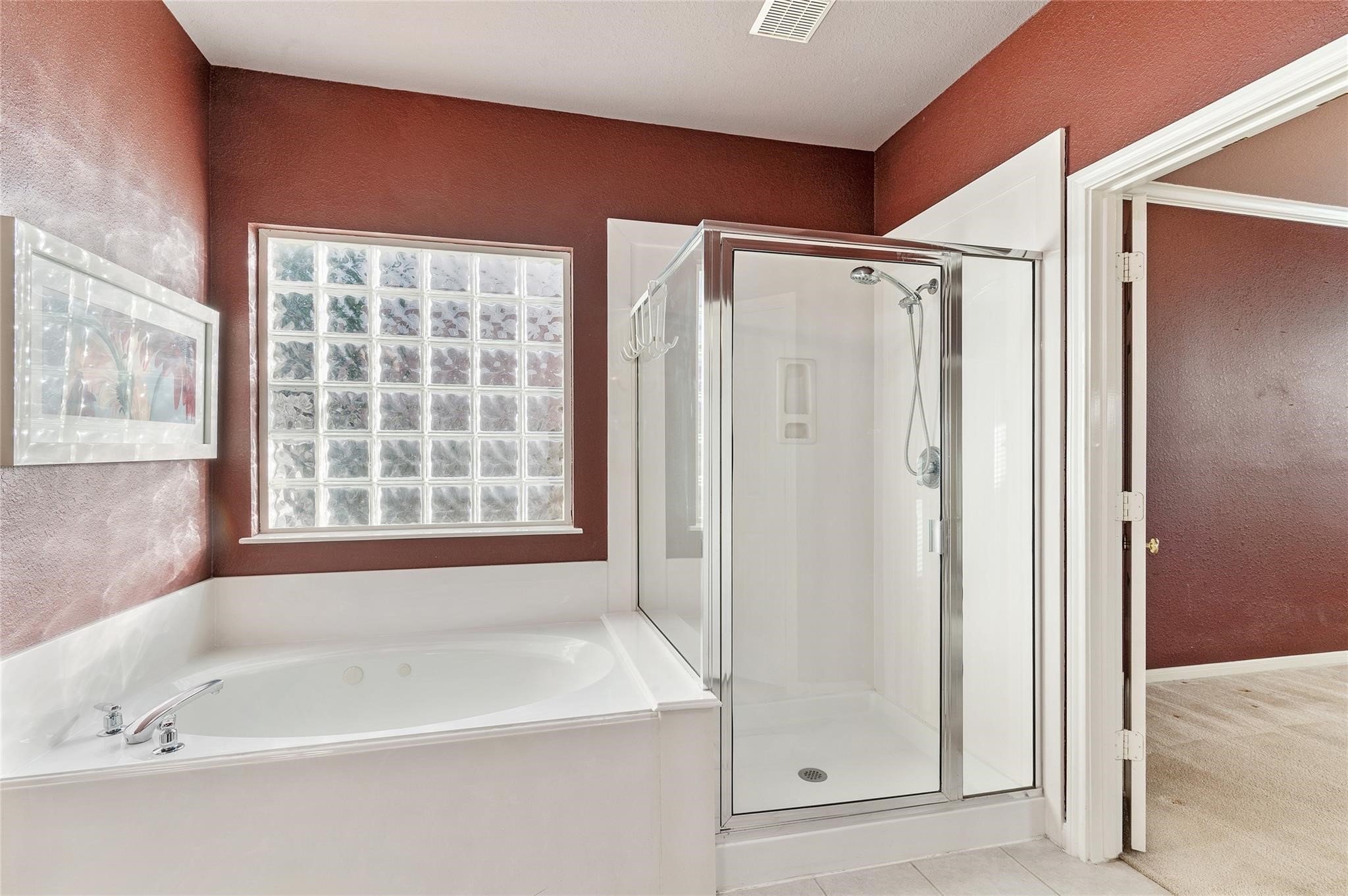 4302 Country Oaks Court Spring, TX 77388 - Photo 16 of 25 a bathroom with a bathtub and a shower