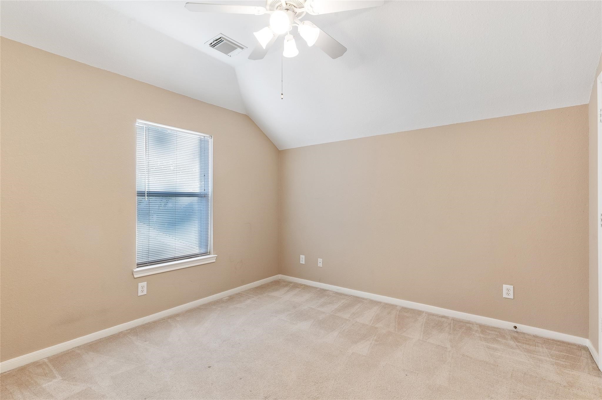 4302 Country Oaks Court Spring, TX 77388 - Photo 19 of 25 an empty room with a chandelier fan and windows