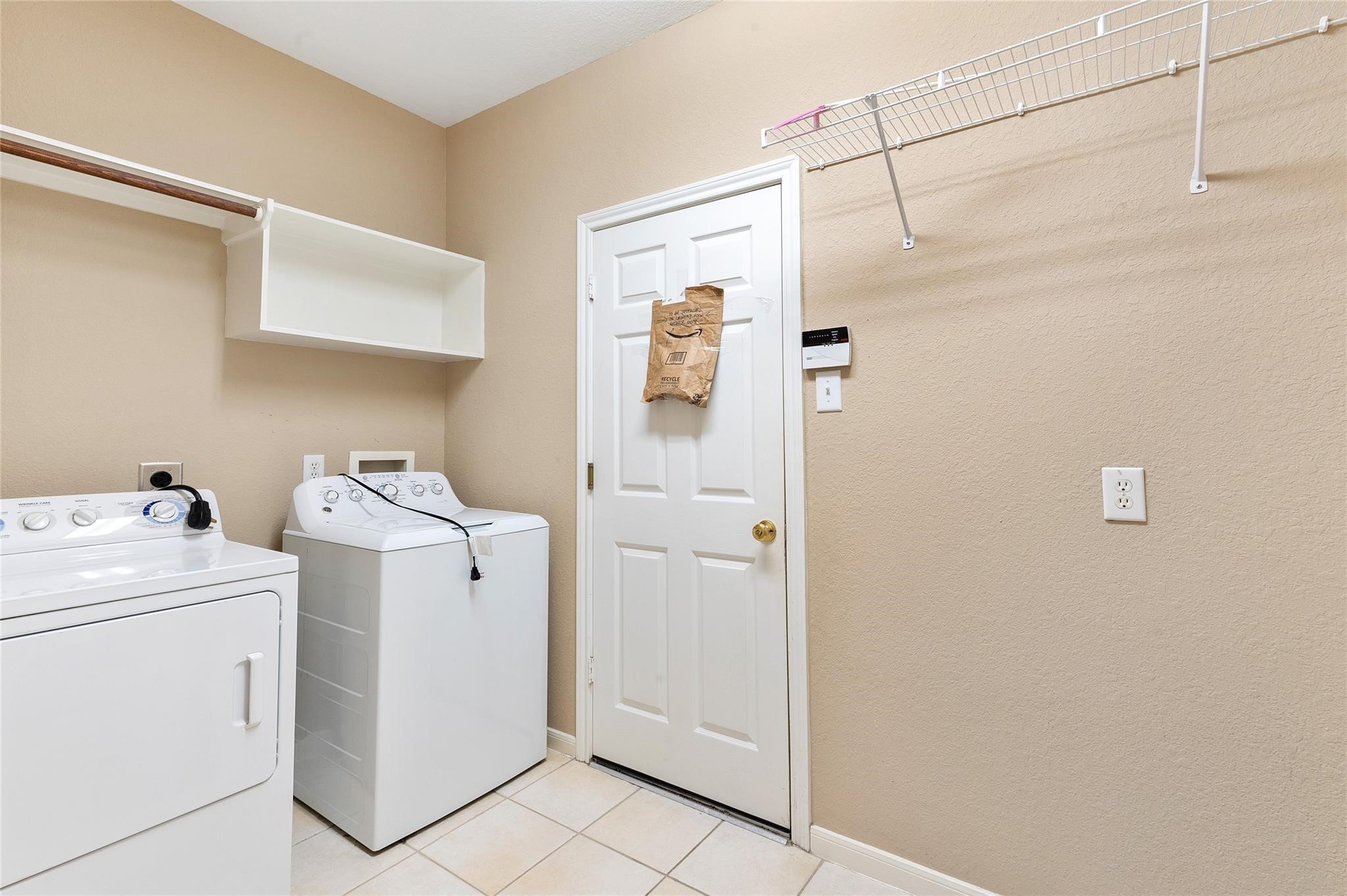 4302 Country Oaks Court Spring, TX 77388 - Photo 23 of 25 a view of a storage & utility room with dryer and washer