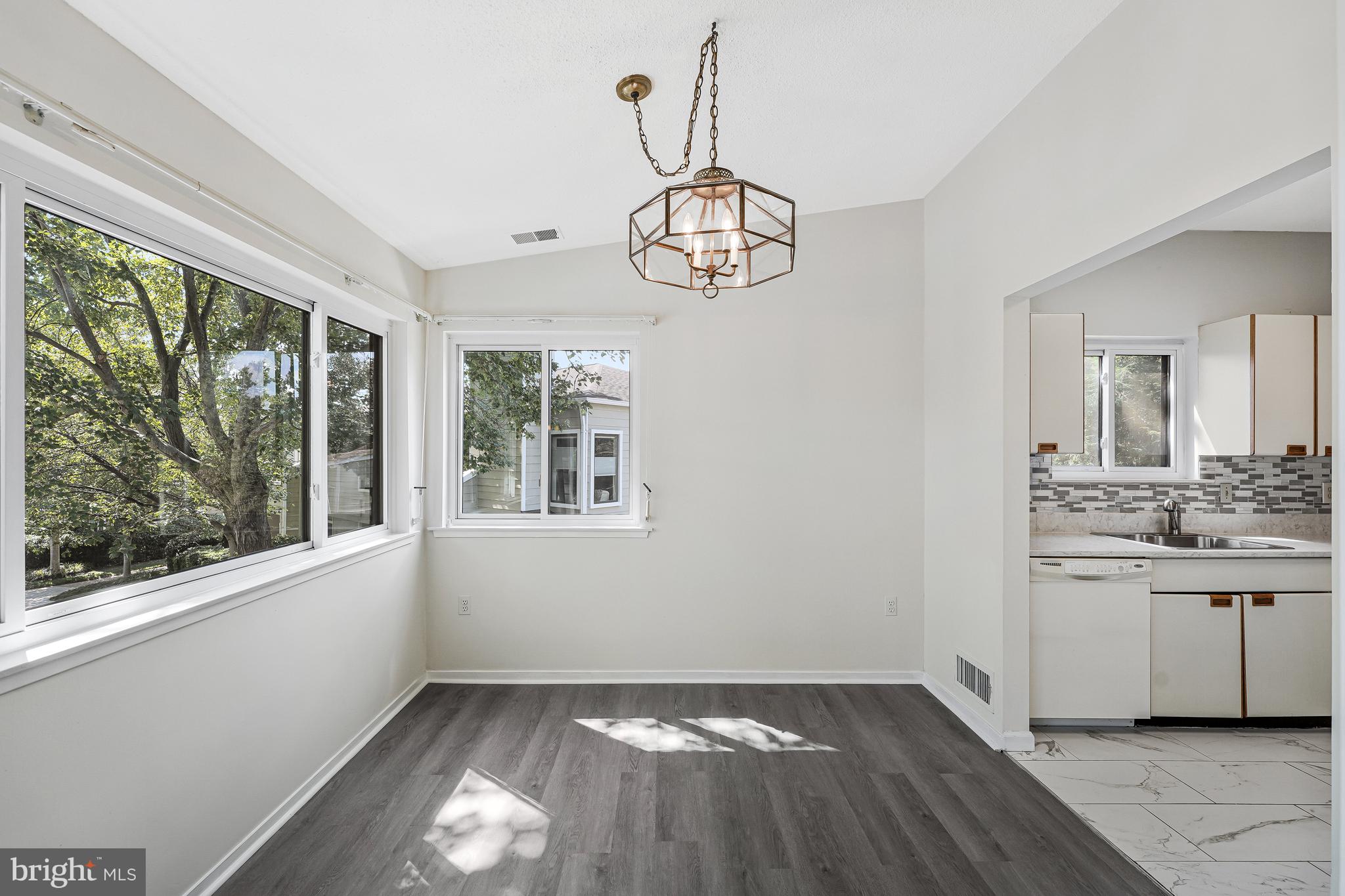 1964 Villaridge Drive Reston, VA 20191 - Photo 11 of 27 a view of an empty room with a window and wooden floor