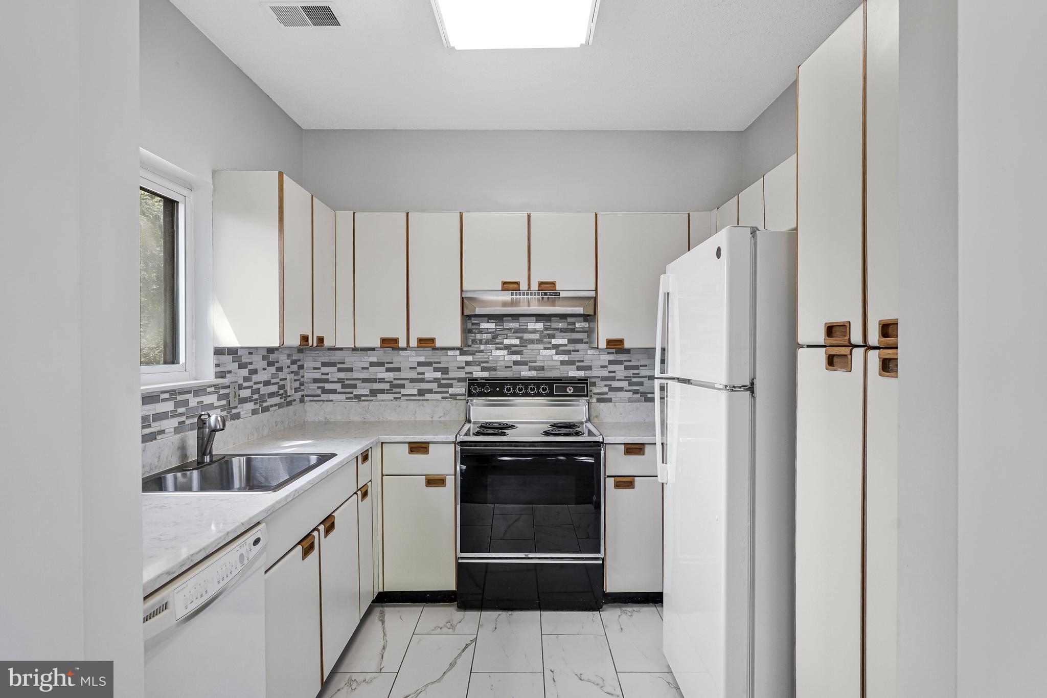 1964 Villaridge Drive Reston, VA 20191 - Photo 13 of 27 a kitchen with a stove sink and refrigerator