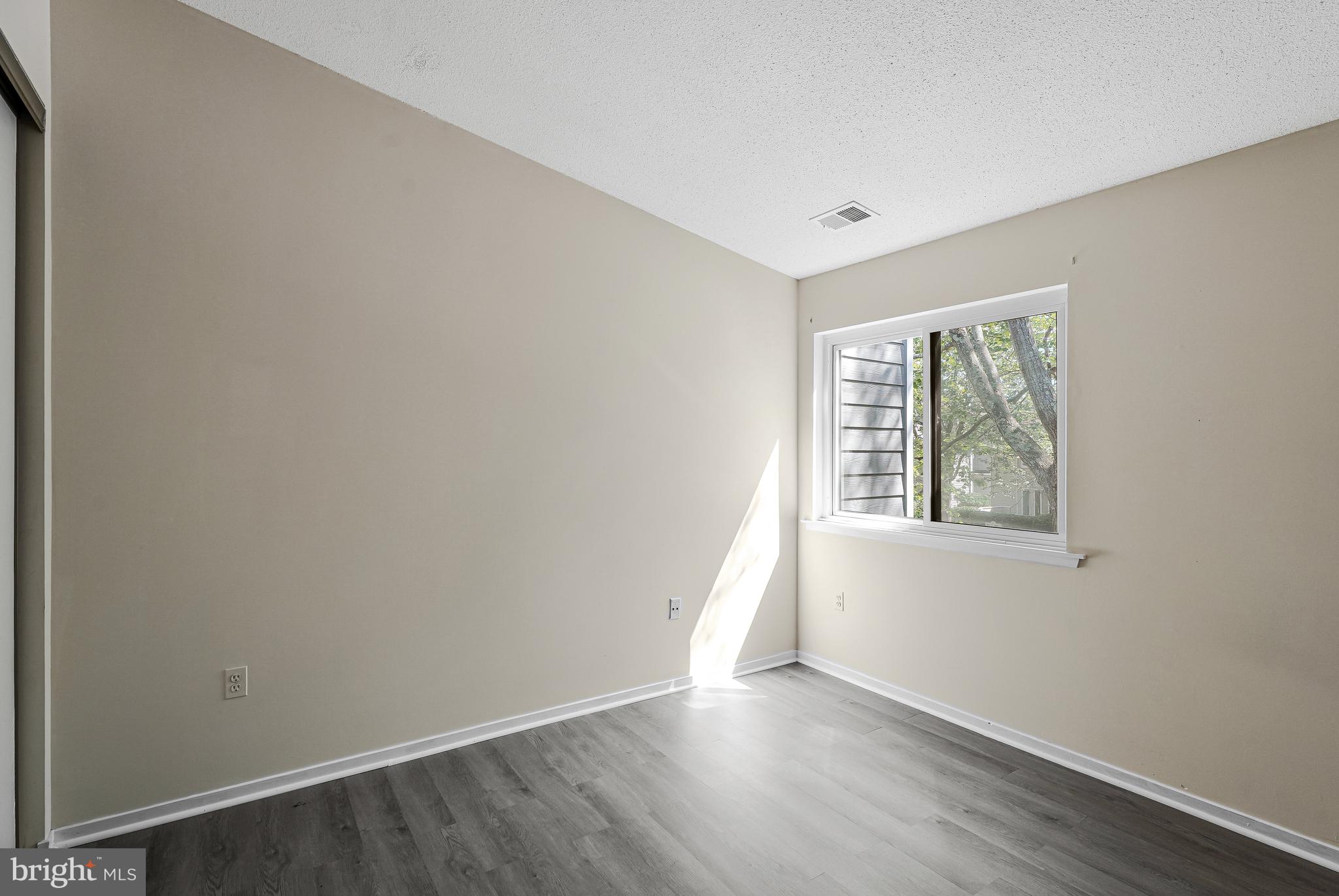 1964 Villaridge Drive Reston, VA 20191 - Photo 16 of 27 an empty room with wooden floor and windows