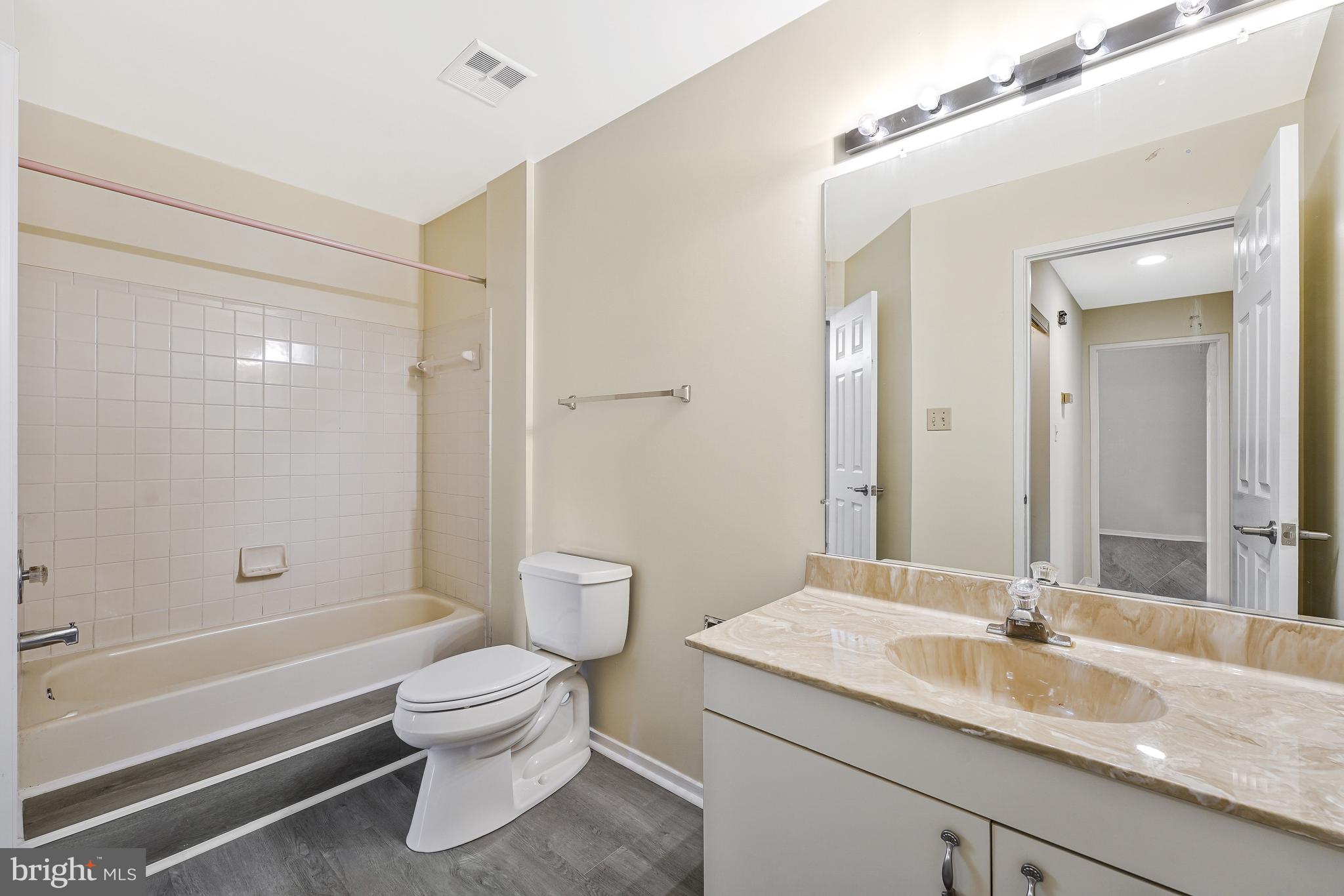 1964 Villaridge Drive Reston, VA 20191 - Photo 19 of 27 a bathroom with a granite countertop sink a toilet and shower