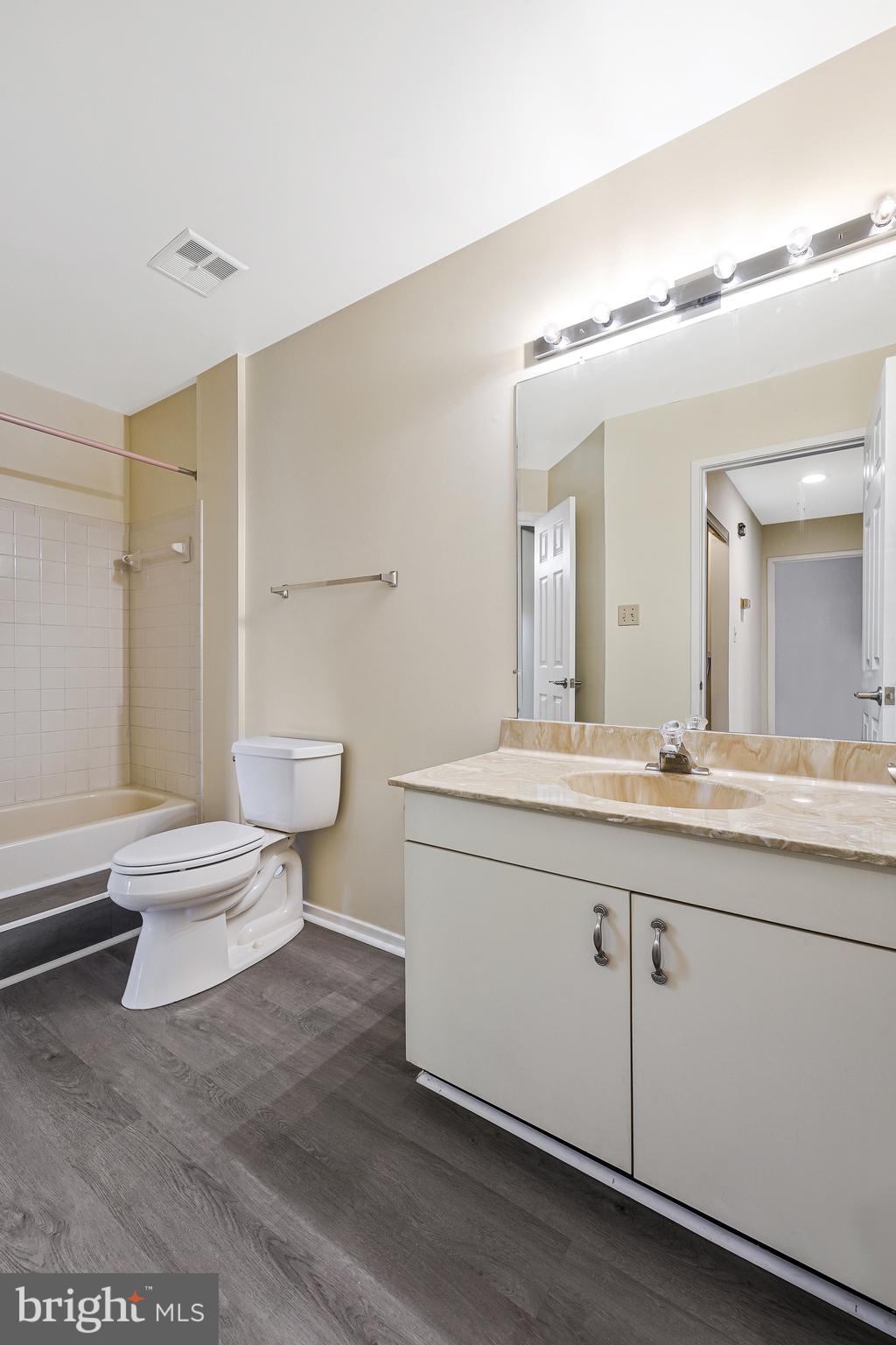 1964 Villaridge Drive Reston, VA 20191 - Photo 20 of 27 a spacious bathroom with a granite countertop sink a toilet and a mirror