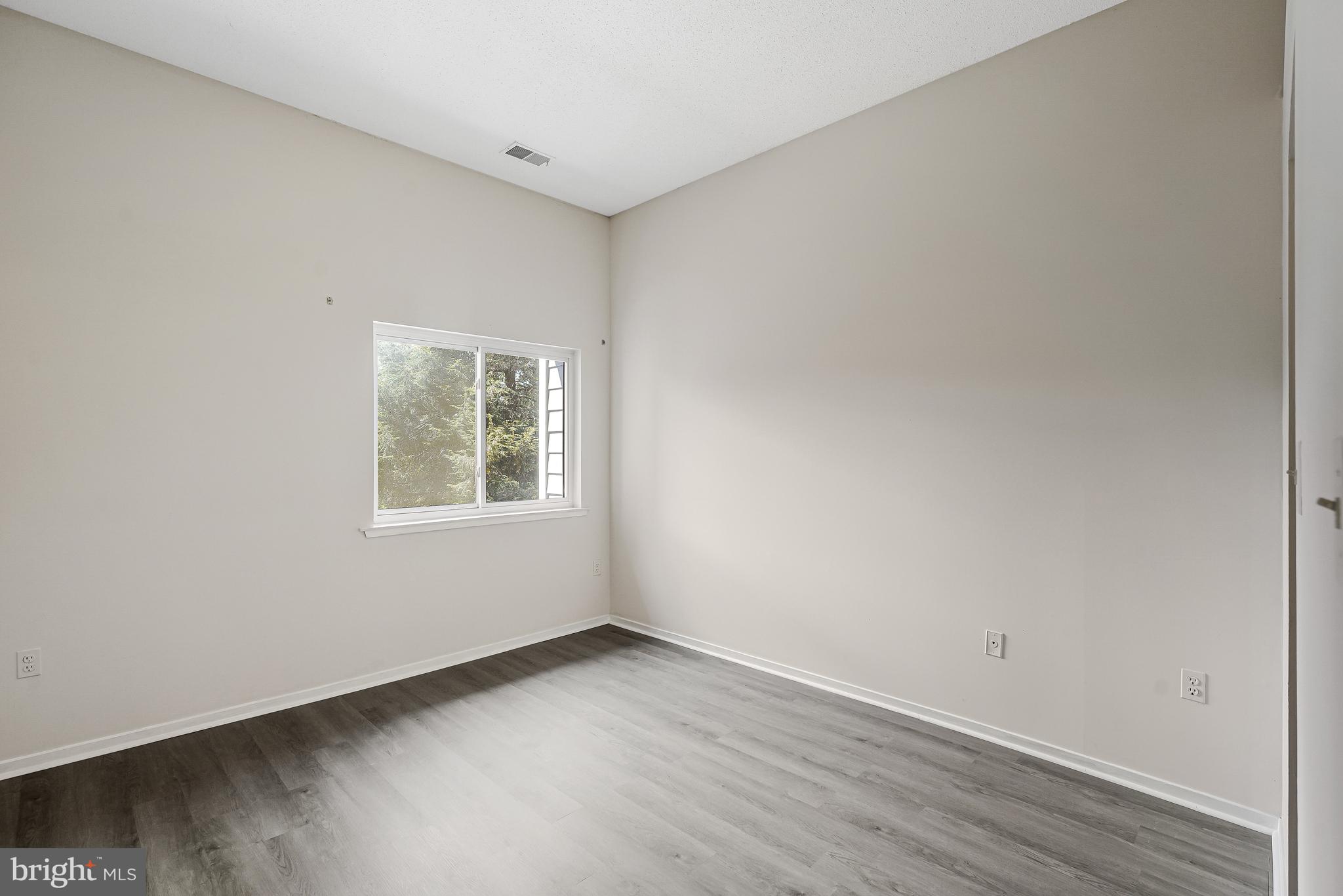 1964 Villaridge Drive Reston, VA 20191 - Photo 22 of 27 an empty room with wooden floor and windows