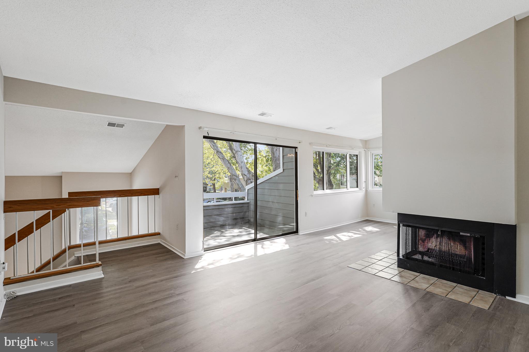 1964 Villaridge Drive Reston, VA 20191 - Photo 7 of 27 a view of an empty room with wooden floor and a window