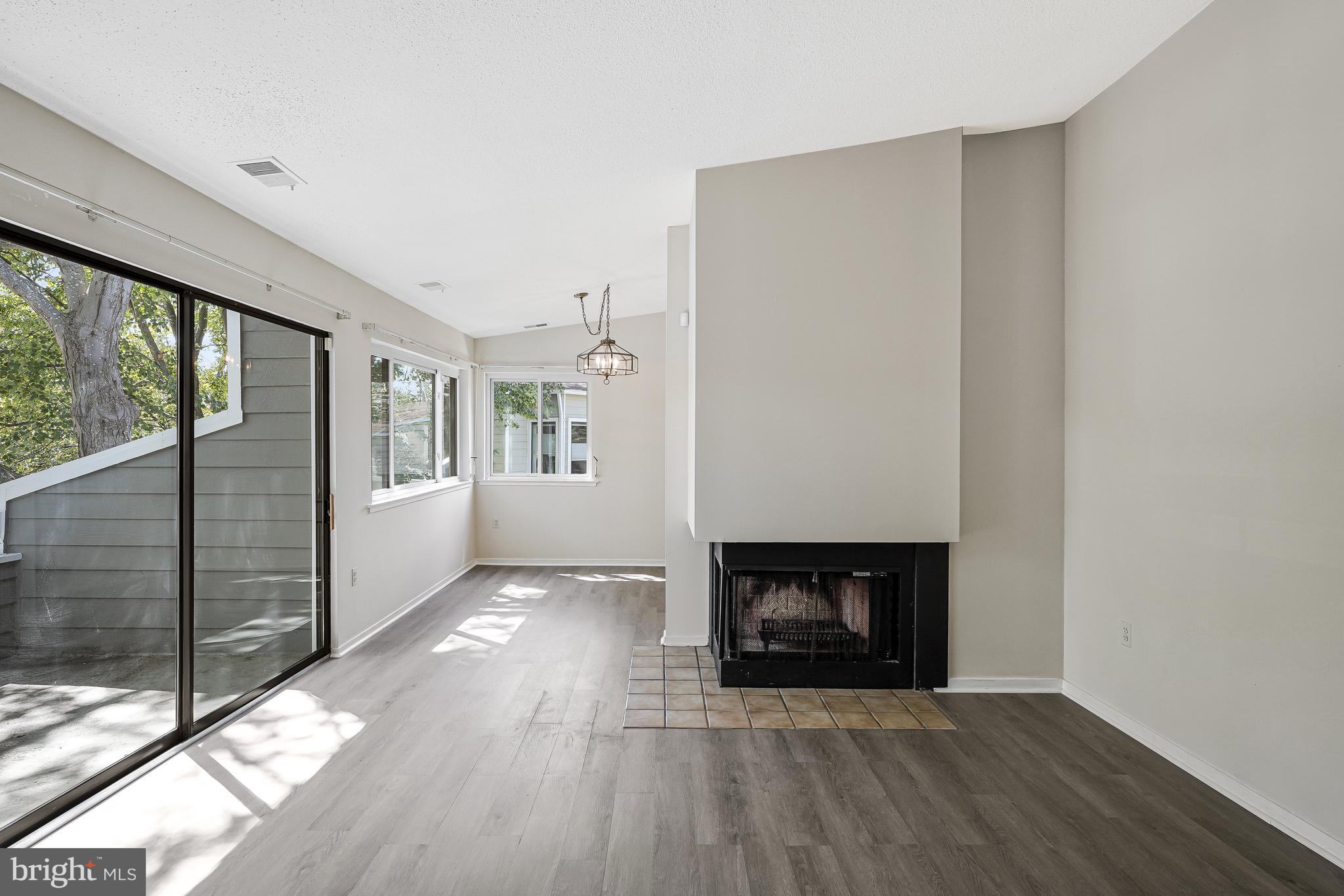 1964 Villaridge Drive Reston, VA 20191 - Photo 9 of 27 a view of a hallway with wooden floor and a fireplace