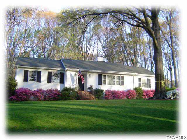 a front view of house with yard and outdoor seating