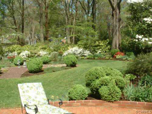 7606 Cheshire Road Richmond, VA 23229 - Photo 2 of 5 a view of a garden with a bench