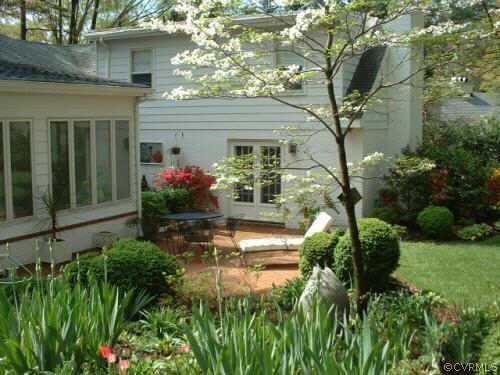 7606 Cheshire Road Richmond, VA 23229 - Photo 3 of 5 a front view of a house with lots of green space