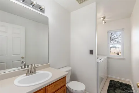 a bathroom with a sink toilet and vanity