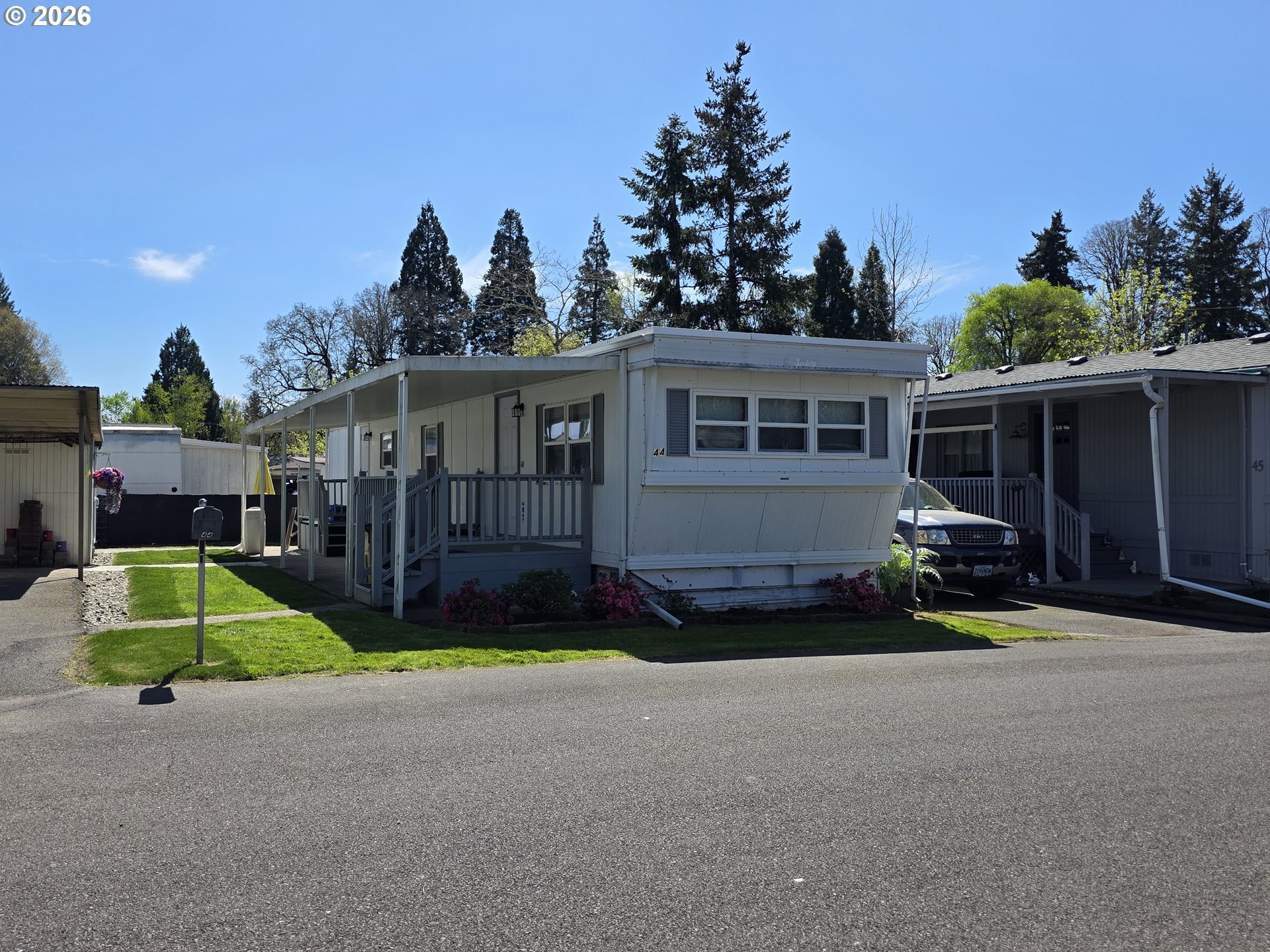 a view of a house with backyard and porch