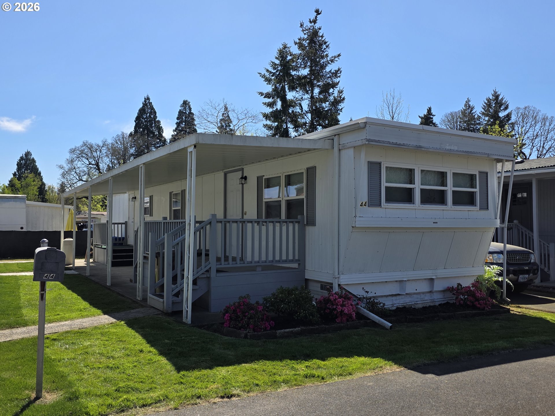 3203 Southeast Vineyard Road, Unit 44 Milwaukie, OR 97267 - Photo 2 of 38 a front view of a house with garden