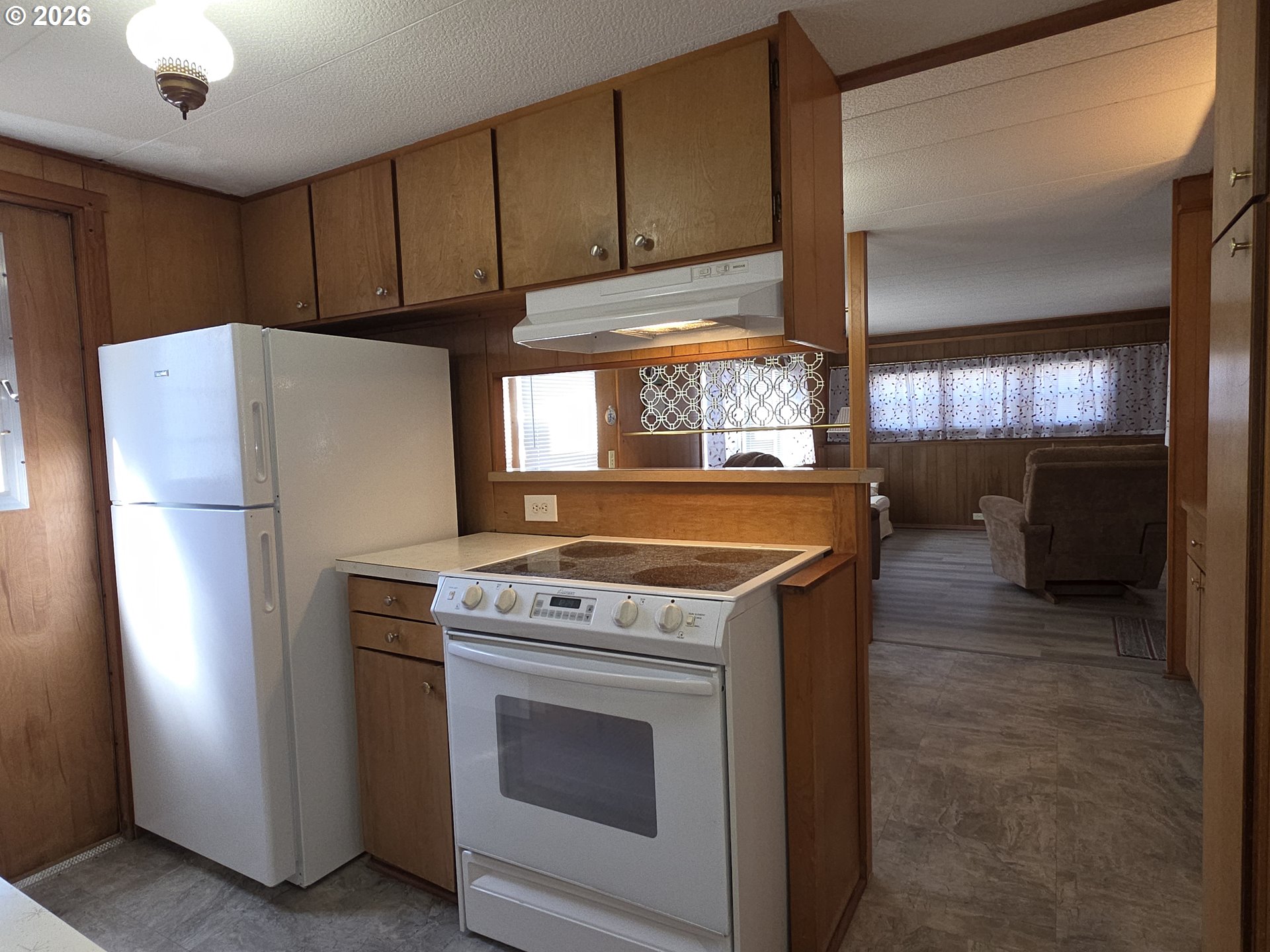3203 Southeast Vineyard Road, Unit 44 Milwaukie, OR 97267 - Photo 29 of 38 a kitchen with a stove refrigerator and cabinets