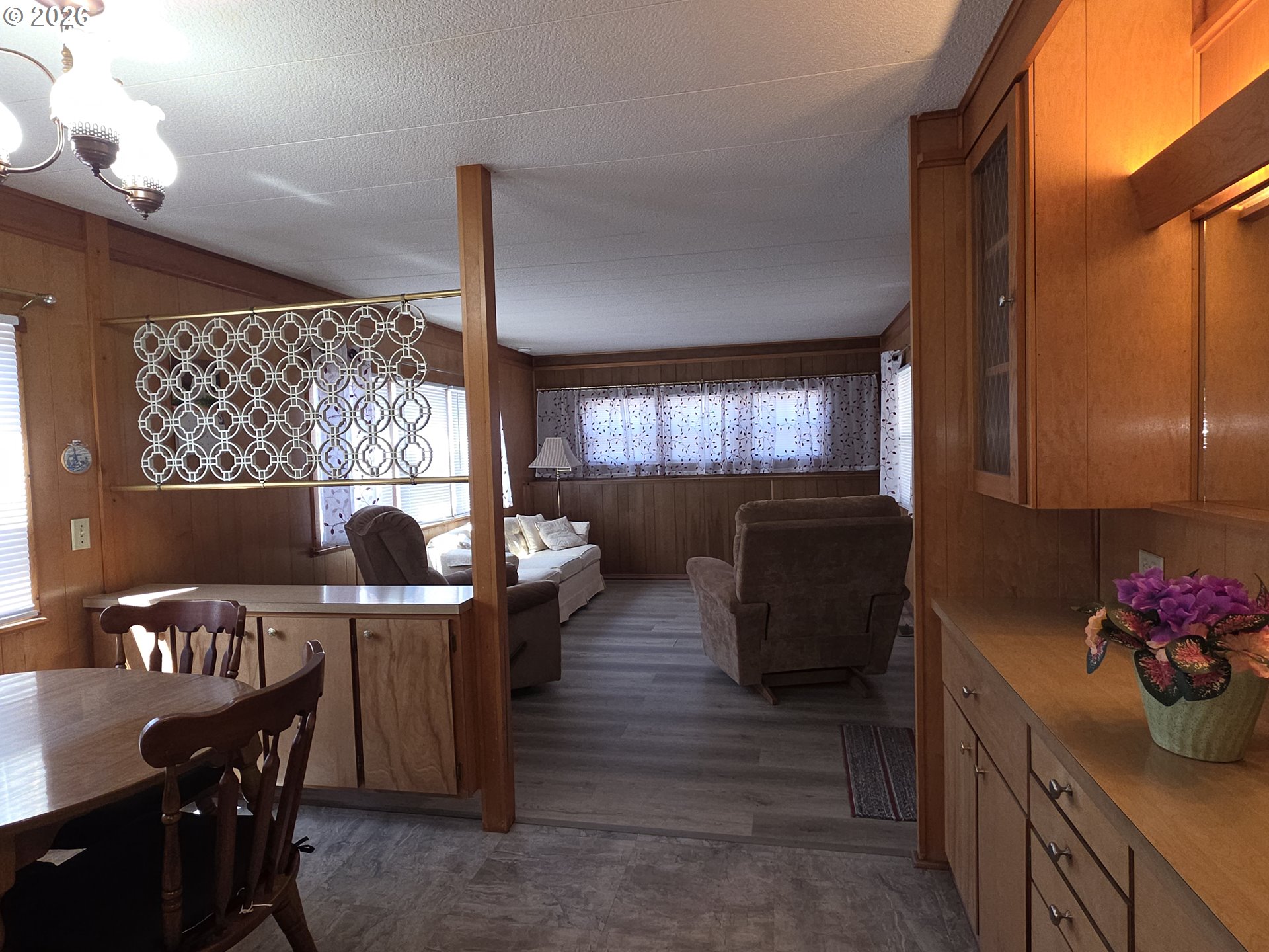 3203 Southeast Vineyard Road, Unit 44 Milwaukie, OR 97267 - Photo 30 of 38 a kitchen with stainless steel appliances kitchen island granite countertop a table chairs in it and a window