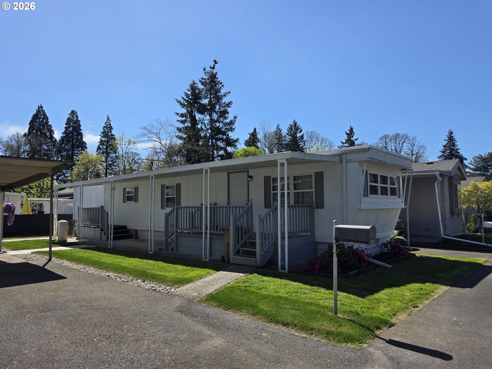 3203 Southeast Vineyard Road, Unit 44 Milwaukie, OR 97267 - Photo 3 of 38 a view of a house with a backyard and a tree