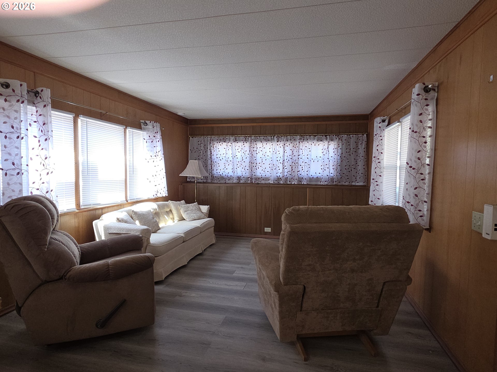 3203 Southeast Vineyard Road, Unit 44 Milwaukie, OR 97267 - Photo 32 of 38 a living room with furniture and a large window