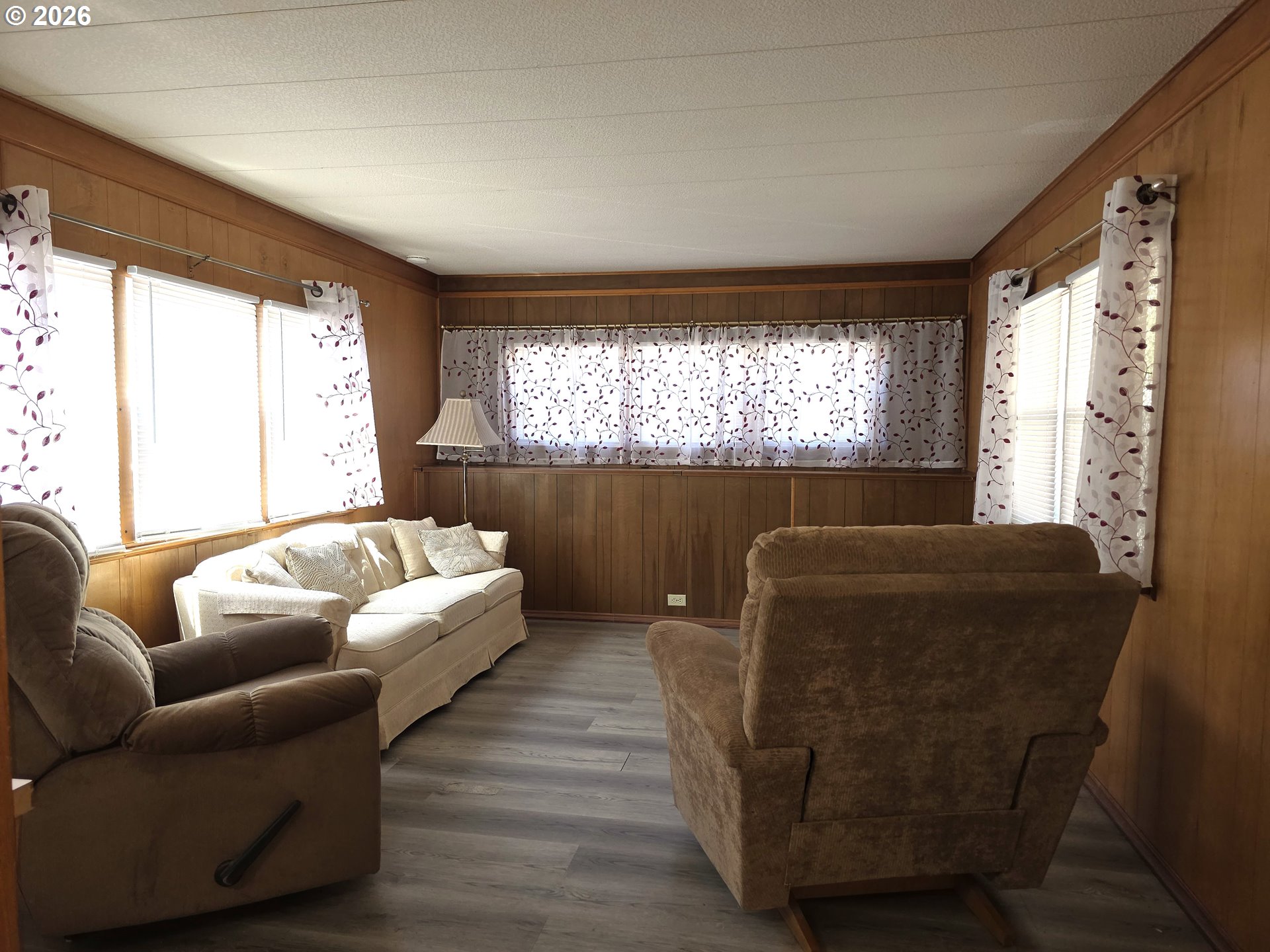 3203 Southeast Vineyard Road, Unit 44 Milwaukie, OR 97267 - Photo 7 of 38 a living room with furniture and a large window