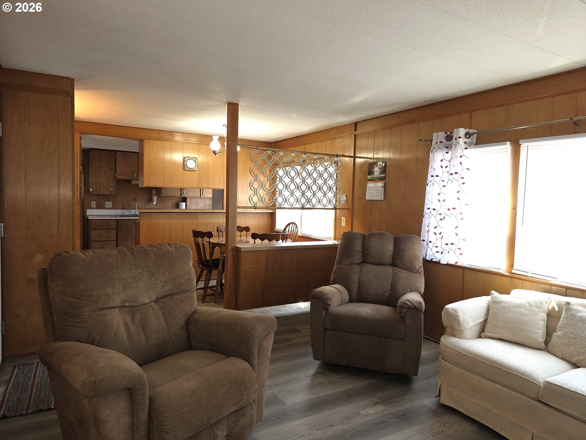 3203 Southeast Vineyard Road, Unit 44 Milwaukie, OR 97267 - Photo 10 of 38 a living room with furniture and a large window