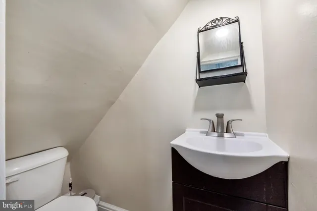 a bathroom with a sink a toilet and mirror