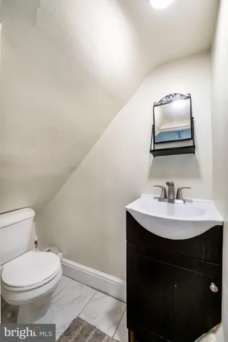 a bathroom with a sink a toilet and mirror
