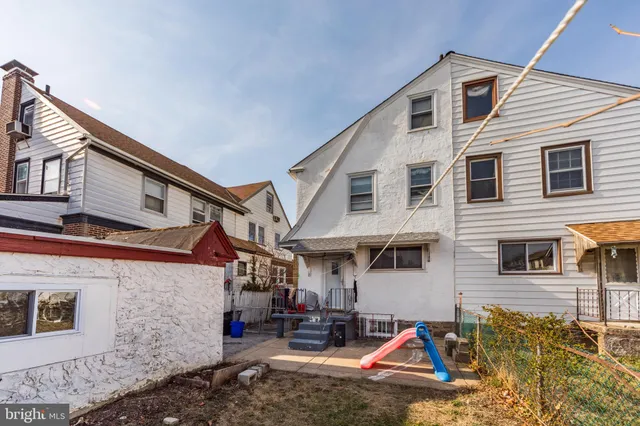 a view of the house with swimming pool and sitting area