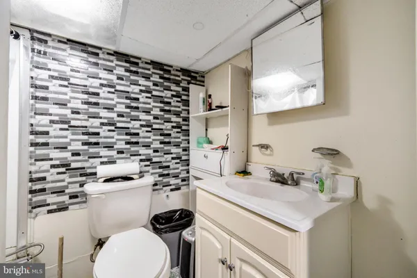 a bathroom with a sink toilet vanity and shower