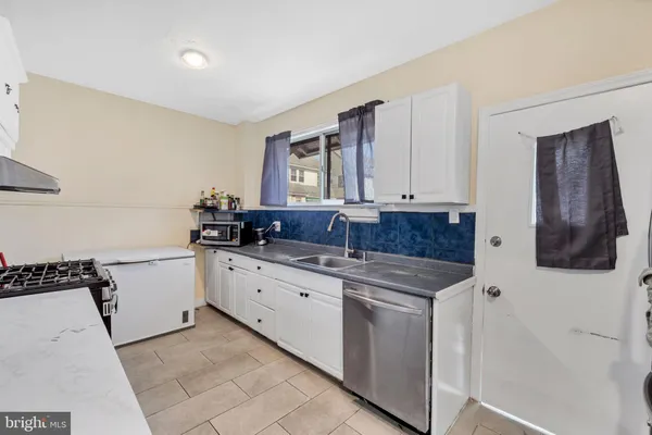 a kitchen with a sink and cabinets
