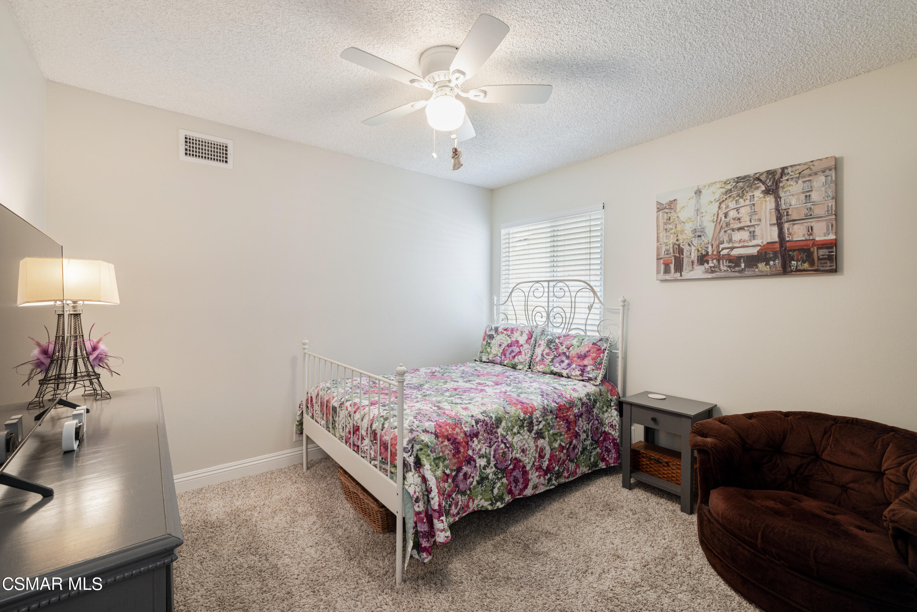 5708 Damon Street Simi Valley, CA 93063 - Photo 19 of 26 a bedroom with a bed couch and a chandelier