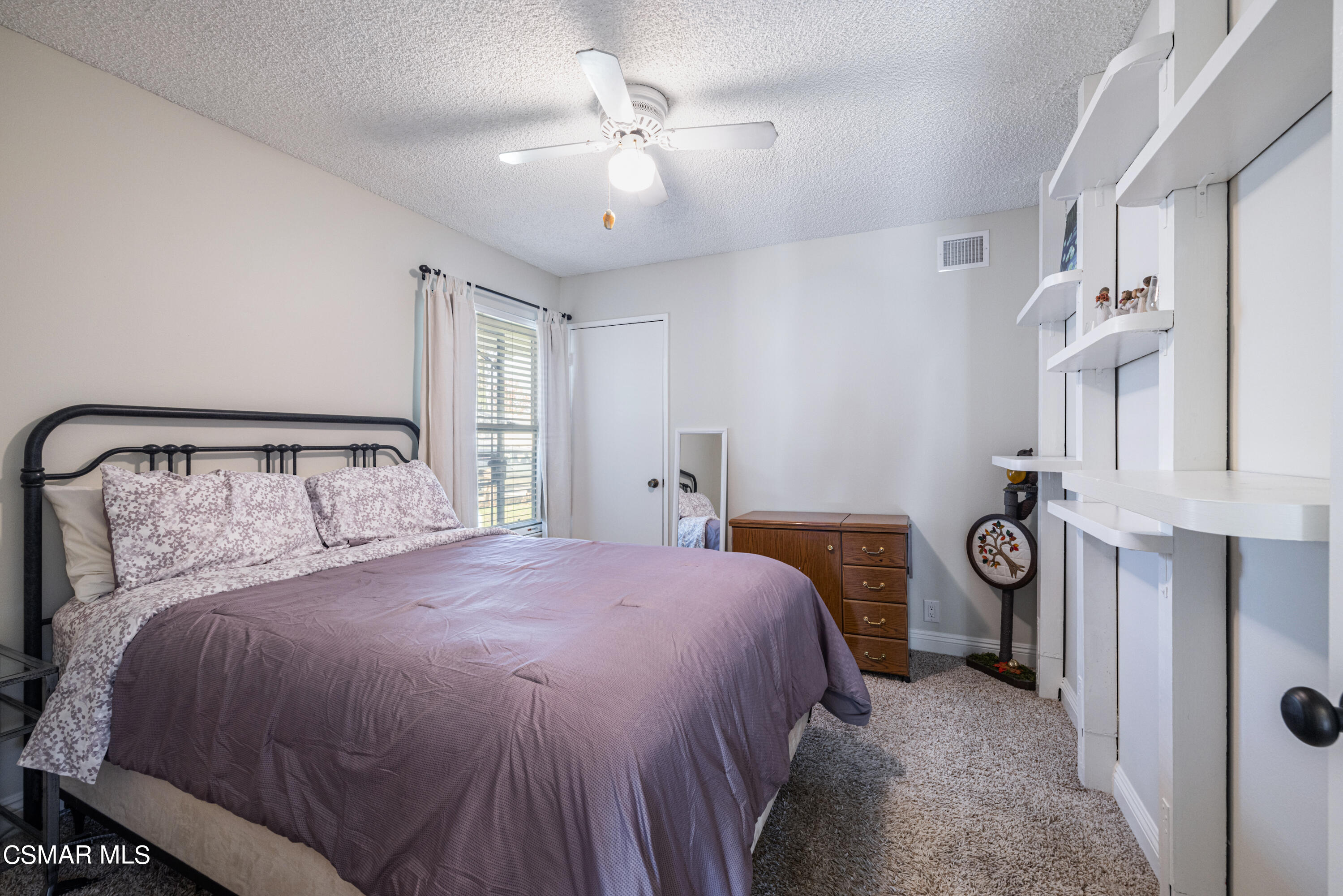 5708 Damon Street Simi Valley, CA 93063 - Photo 20 of 26 a bedroom with a bed and a chandelier
