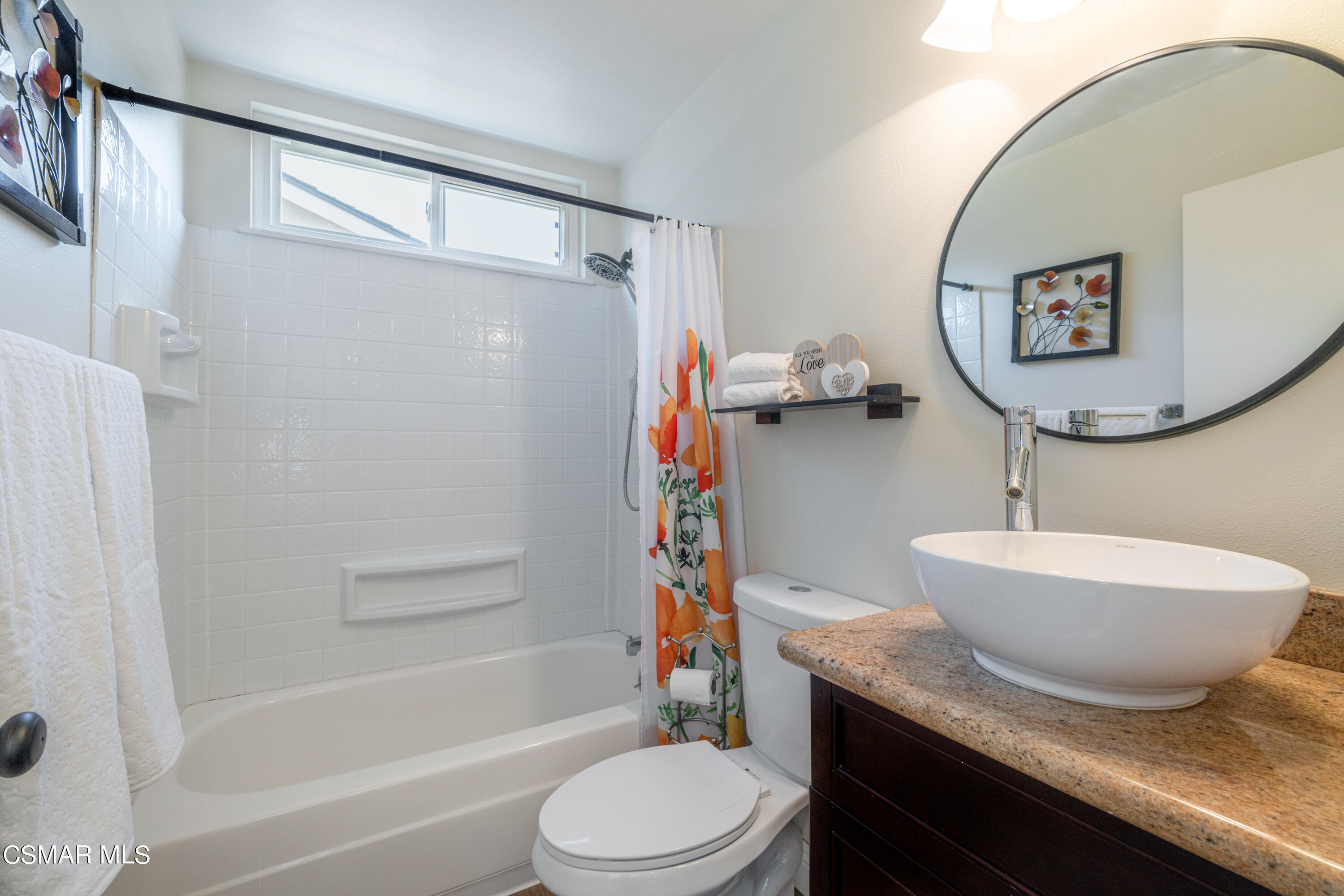 5708 Damon Street Simi Valley, CA 93063 - Photo 21 of 26 a bathroom with a granite countertop sink toilet a mirror and shower