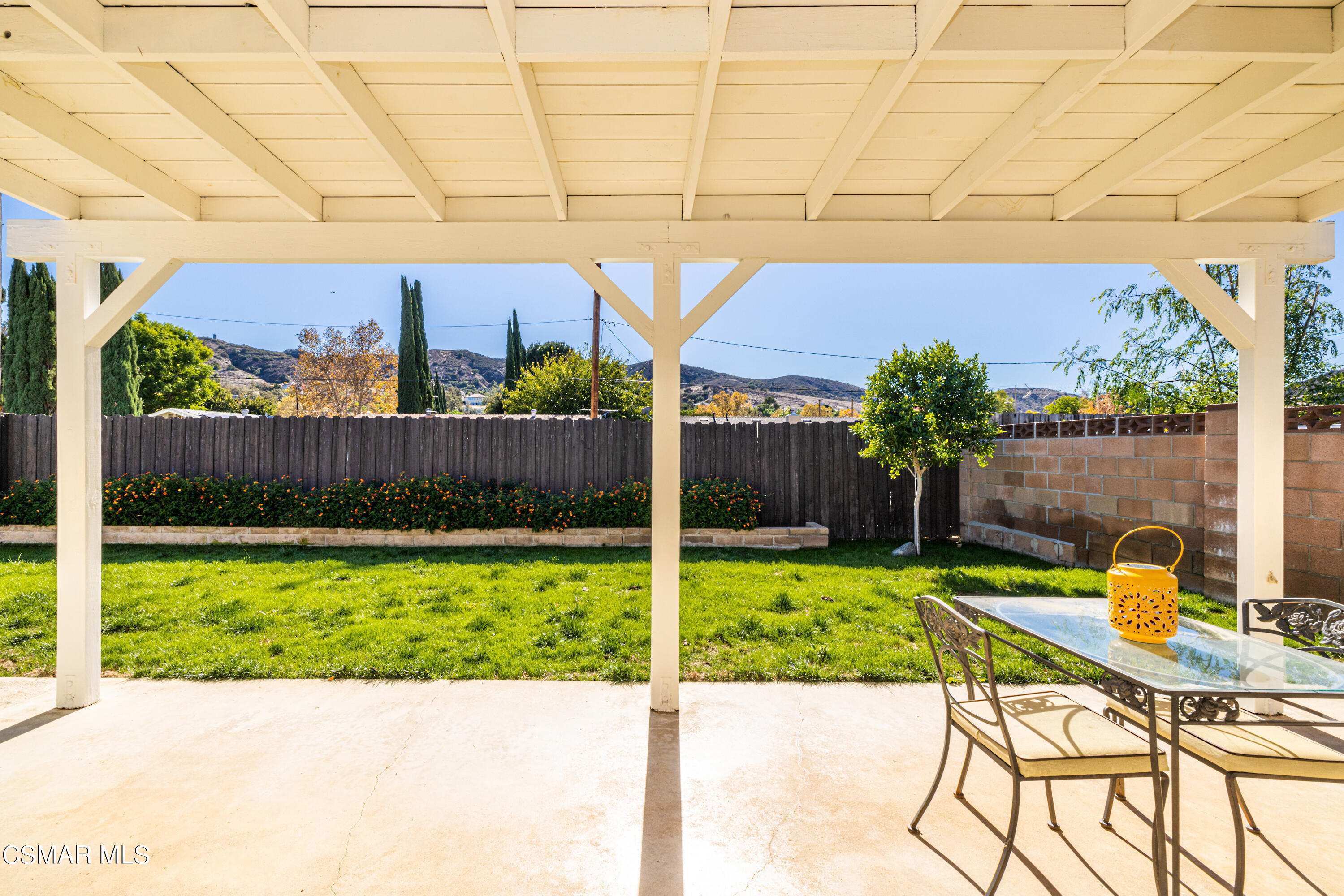 5708 Damon Street Simi Valley, CA 93063 - Photo 22 of 26 a view of a chairs and table in the back yard