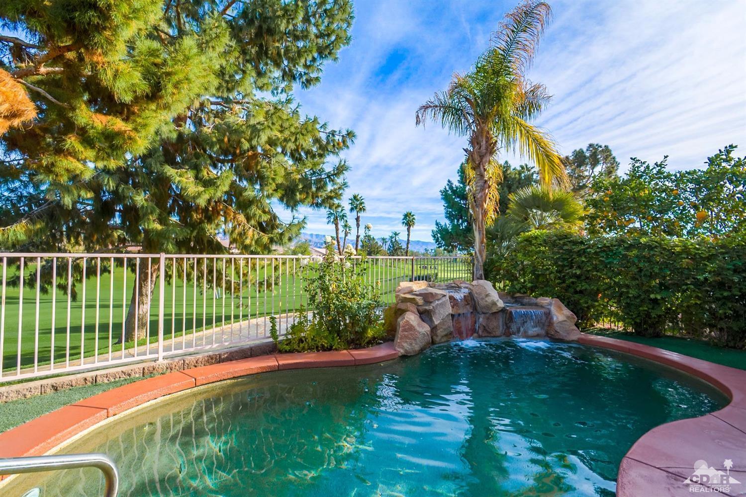 39515 Manorgate Road Palm Desert, CA 92211 - Photo 2 of 42 a view of a garden with a bench in the background