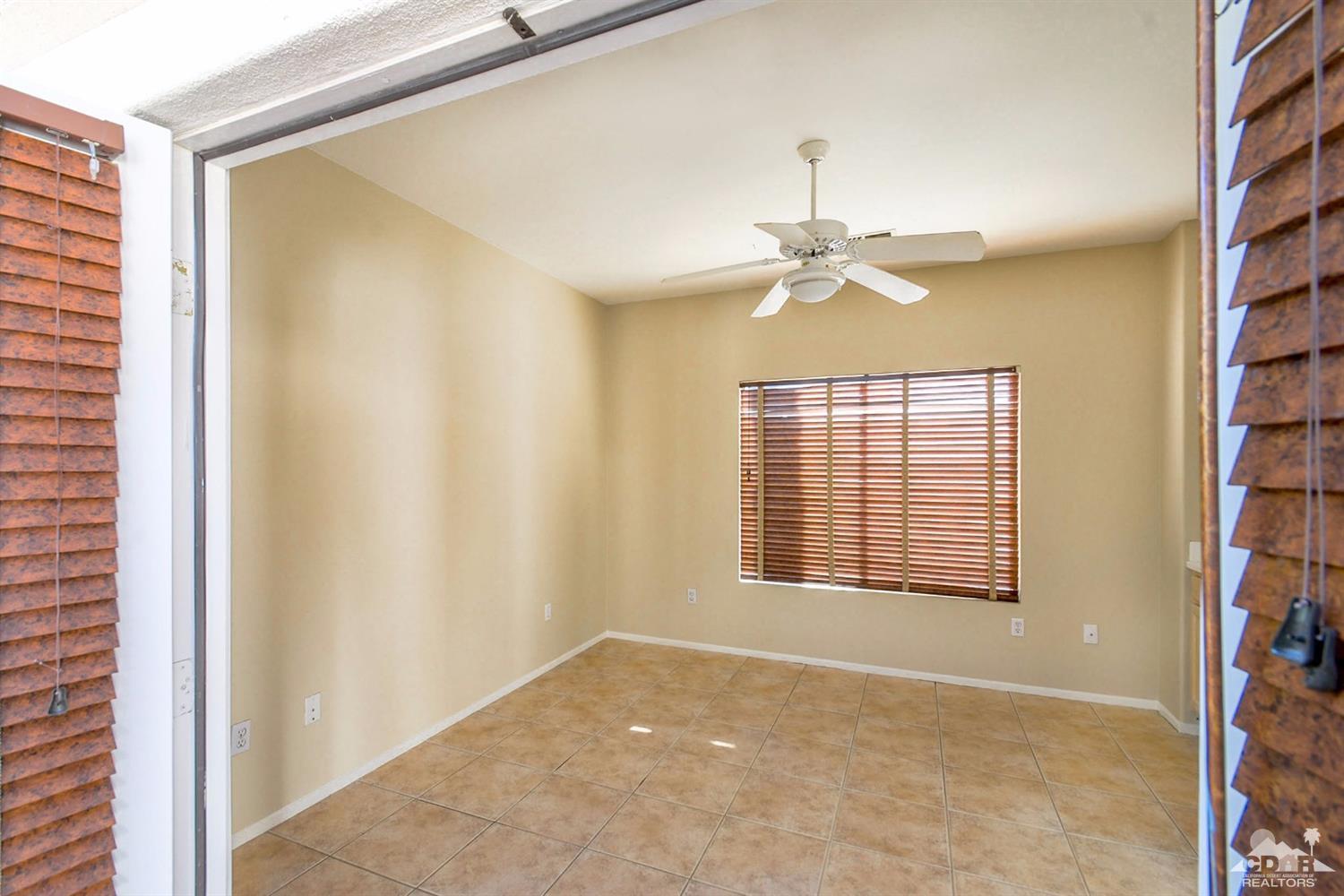 39515 Manorgate Road Palm Desert, CA 92211 - Photo 11 of 42 a view of an empty room with a window