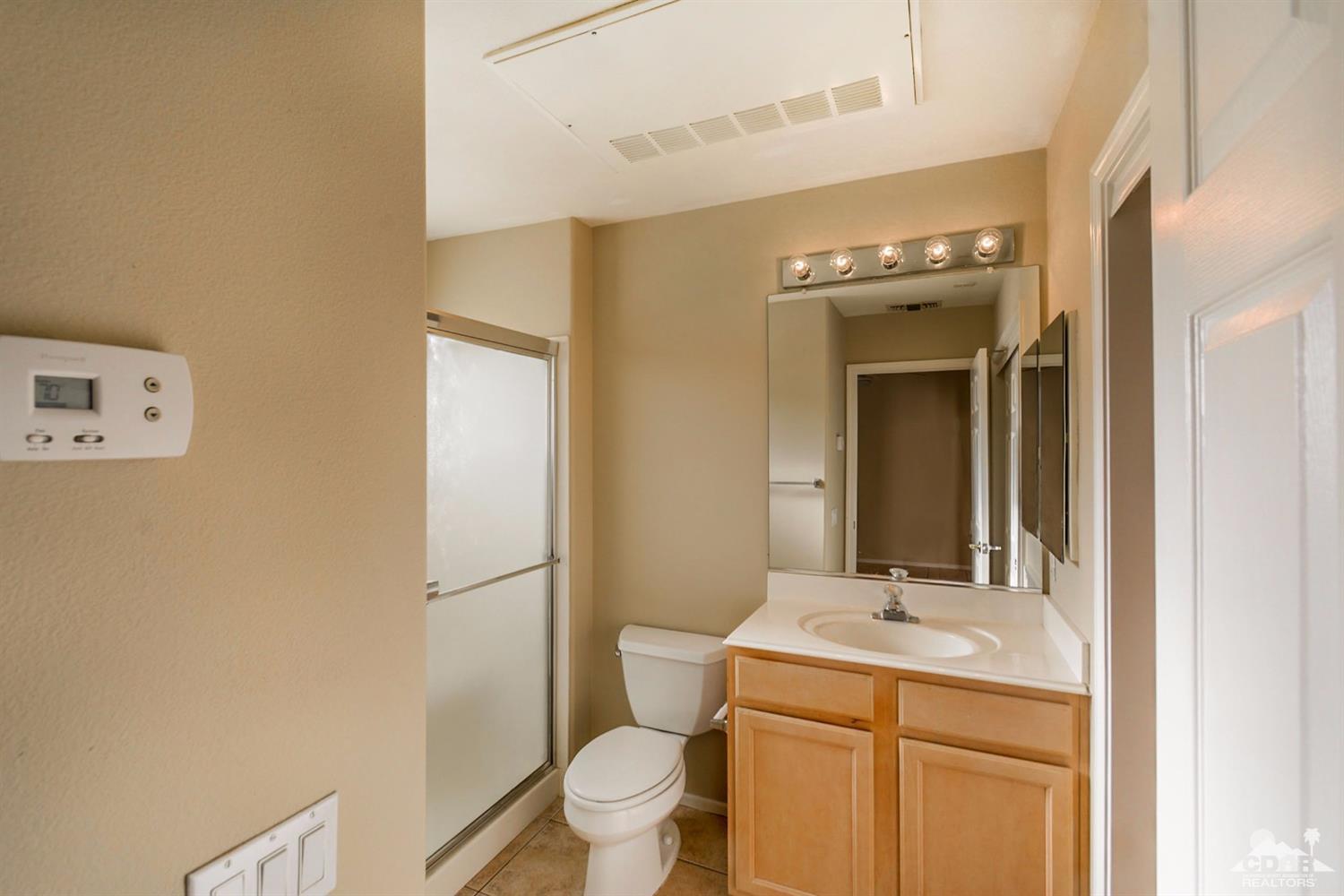 39515 Manorgate Road Palm Desert, CA 92211 - Photo 13 of 42 a bathroom with a sink a toilet and shower