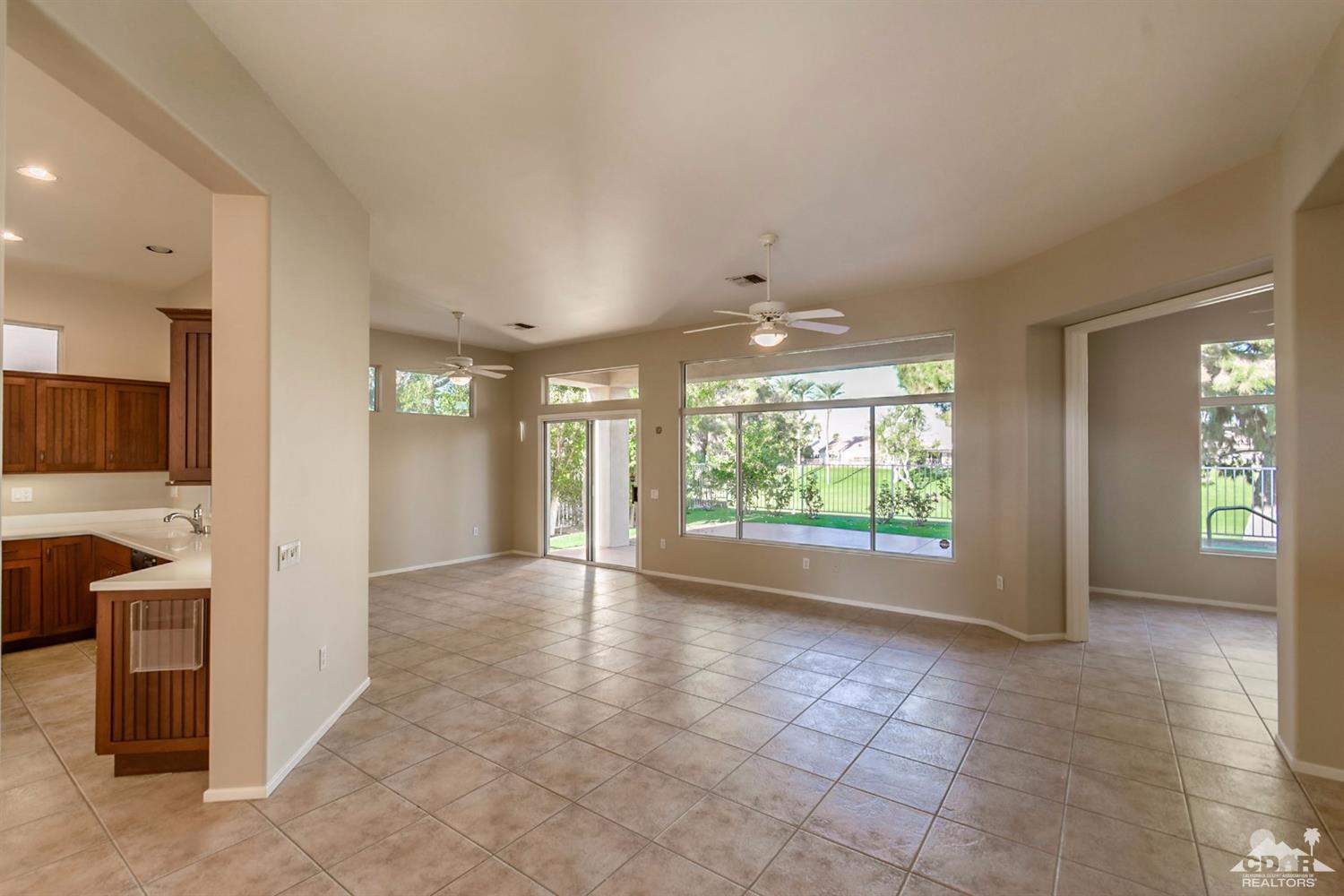 39515 Manorgate Road Palm Desert, CA 92211 - Photo 15 of 42 an empty room with windows and fireplace