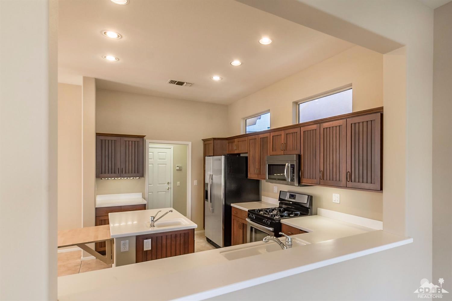 39515 Manorgate Road Palm Desert, CA 92211 - Photo 21 of 42 a room with gym equipment and wooden floor