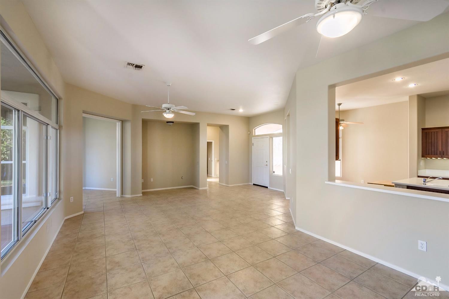 39515 Manorgate Road Palm Desert, CA 92211 - Photo 22 of 42 a view of a hallway with chandelier and a window