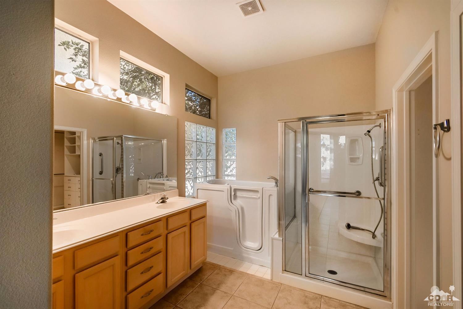 39515 Manorgate Road Palm Desert, CA 92211 - Photo 27 of 42 a bathroom with a double vanity sink mirror and shower