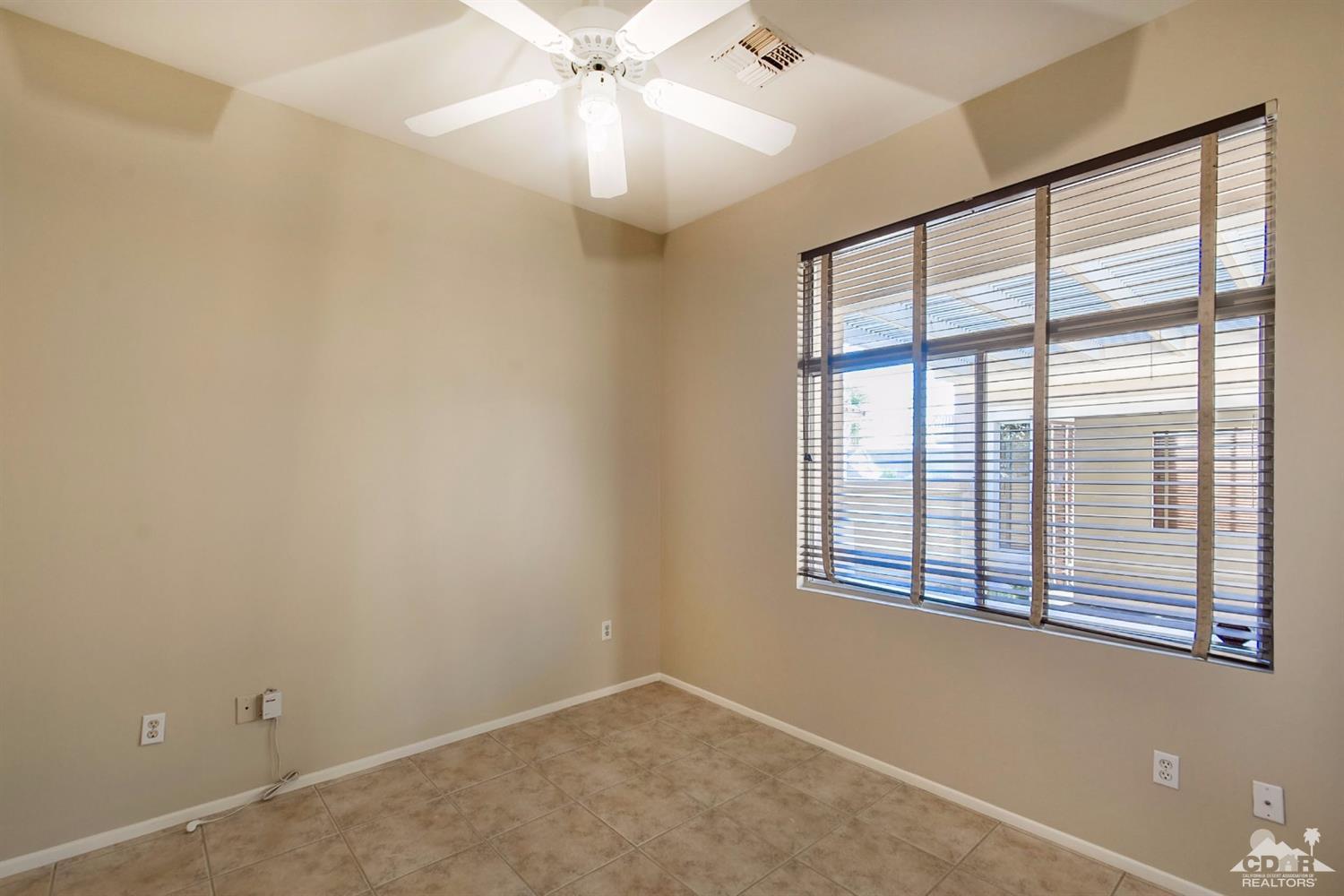39515 Manorgate Road Palm Desert, CA 92211 - Photo 29 of 42 a view of an empty room with a window