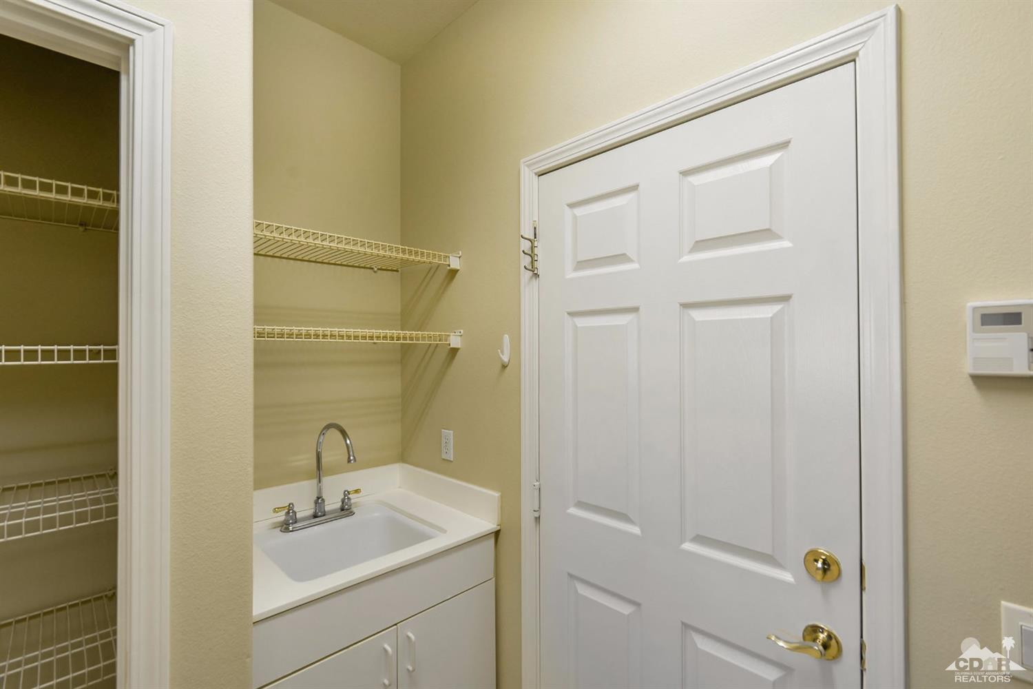 39515 Manorgate Road Palm Desert, CA 92211 - Photo 32 of 42 a bathroom with a sink and mirror